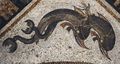 Roman-era floor mosaic on Delos depicting Eros riding on dolphins, c. 120–80 BCE.jpeg